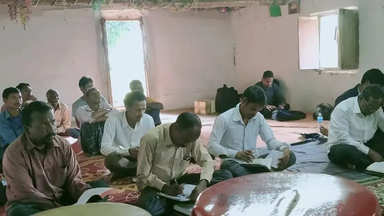 men's Bible study group sitting on the floor