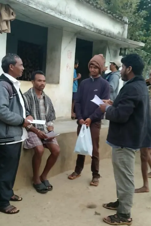 Group of men talking outside a meeting hall