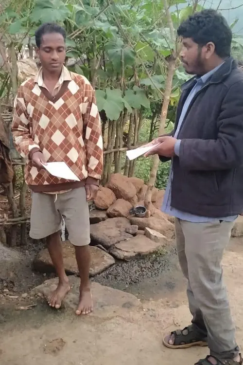man handing a leaflet to another man