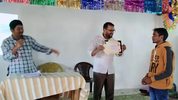 man receiving a certificate at a public ceremony