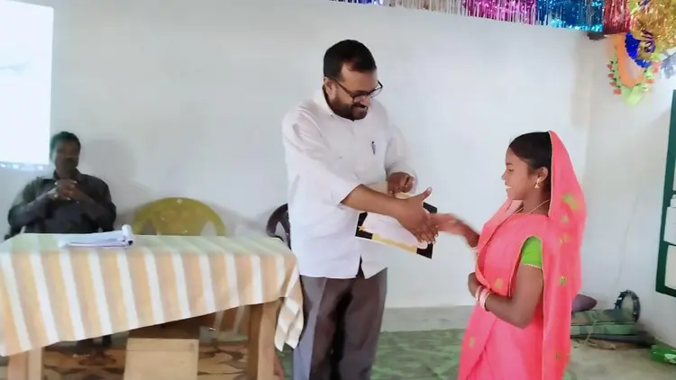 young woman receiving certificate at public ceremony