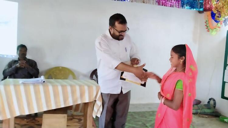 young woman receiving certificate at public ceremony